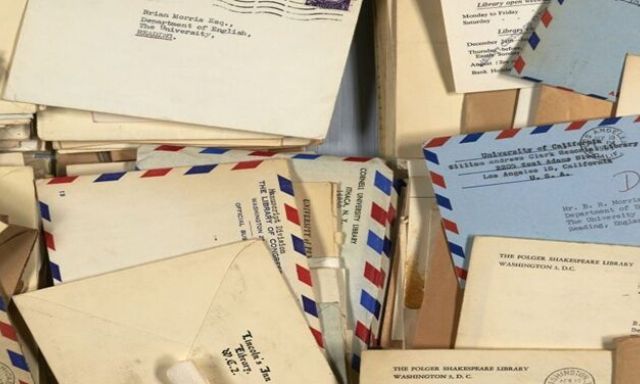 A pile of letters from the late 1950s showing colourful designs and stamps